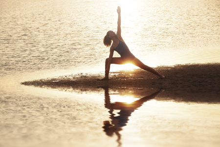 Yoga on the beach at sunset